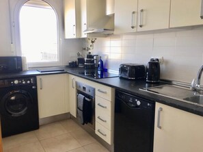 Coffee/tea maker, fridge, microwave, oven