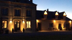 A large, two-story building with a symmetrical facade, multiple windows, and a central entrance. - Chambres Le Tirel (Reux)