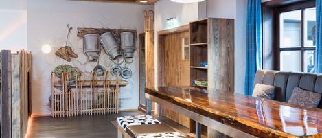 A modern kitchen with wooden accents, a bar area, and a seating space with a view.