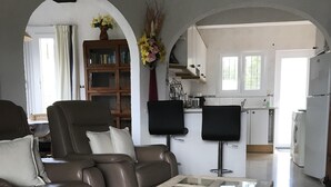 A living room with a brown leather sofa, a glass-top coffee table, and a shaggy rug. - quietly situated villa at 900 m from the beach (Benissa)