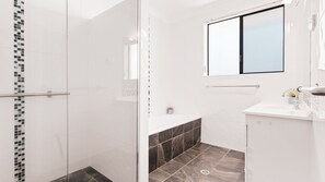 Combined shower/tub, hair dryer, towels - 95 Ocean Drive - Panoramic Ocean Views Over The Pacific (EVANS HEAD)