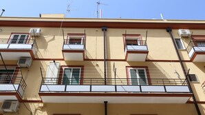 A multi-story building with balconies, air conditioning units, and a clear blue sky. - LA CASA DEI PARGOLI, apartment ideal for pleasant holidays in Matera (Matera)