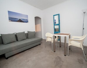 Panoramic Suite, Terrace, Sea View | Living room | Flat-screen TV - Corrado Caldera Apartments (Santorini)