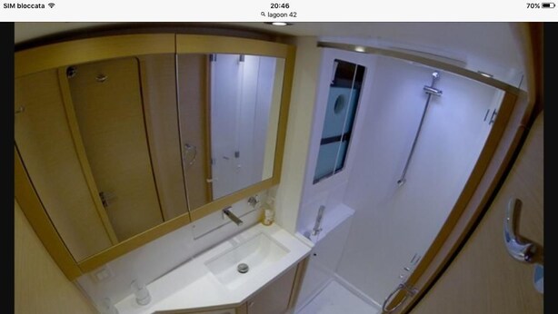 A bathroom with a sink, toilet, and mirror. - Catacruises (Rome)