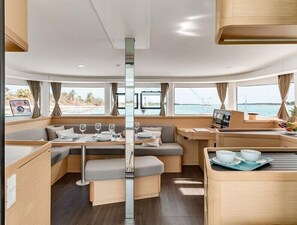 A modern interior with a dining area, seating, and a TV. - Catacruises (Rome)
