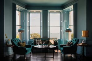 A room with a large bay window, a sofa set, two armchairs, a round coffee table, and two floor lamps. - Haddington House Hotel (Dublin)