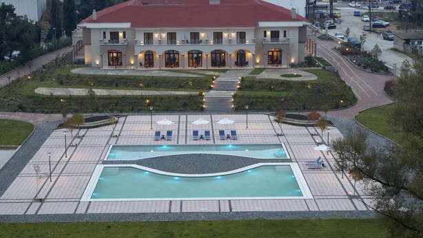 A large building with a swimming pool, outdoor seating, and a well-maintained garden. - The Lake Hotel (Ioannina)