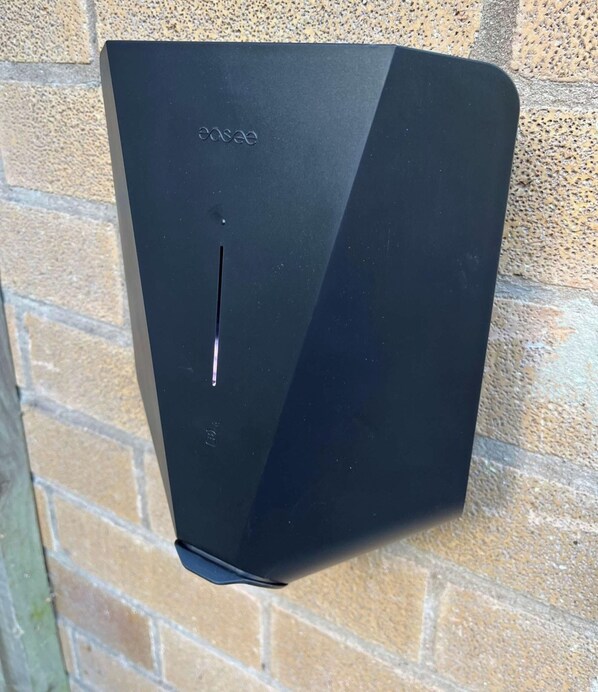 A black, rectangular object with a cut-out on the front, mounted on a brick wall. - Lovely 4 bedroom detached house in Southwell (Southwell)