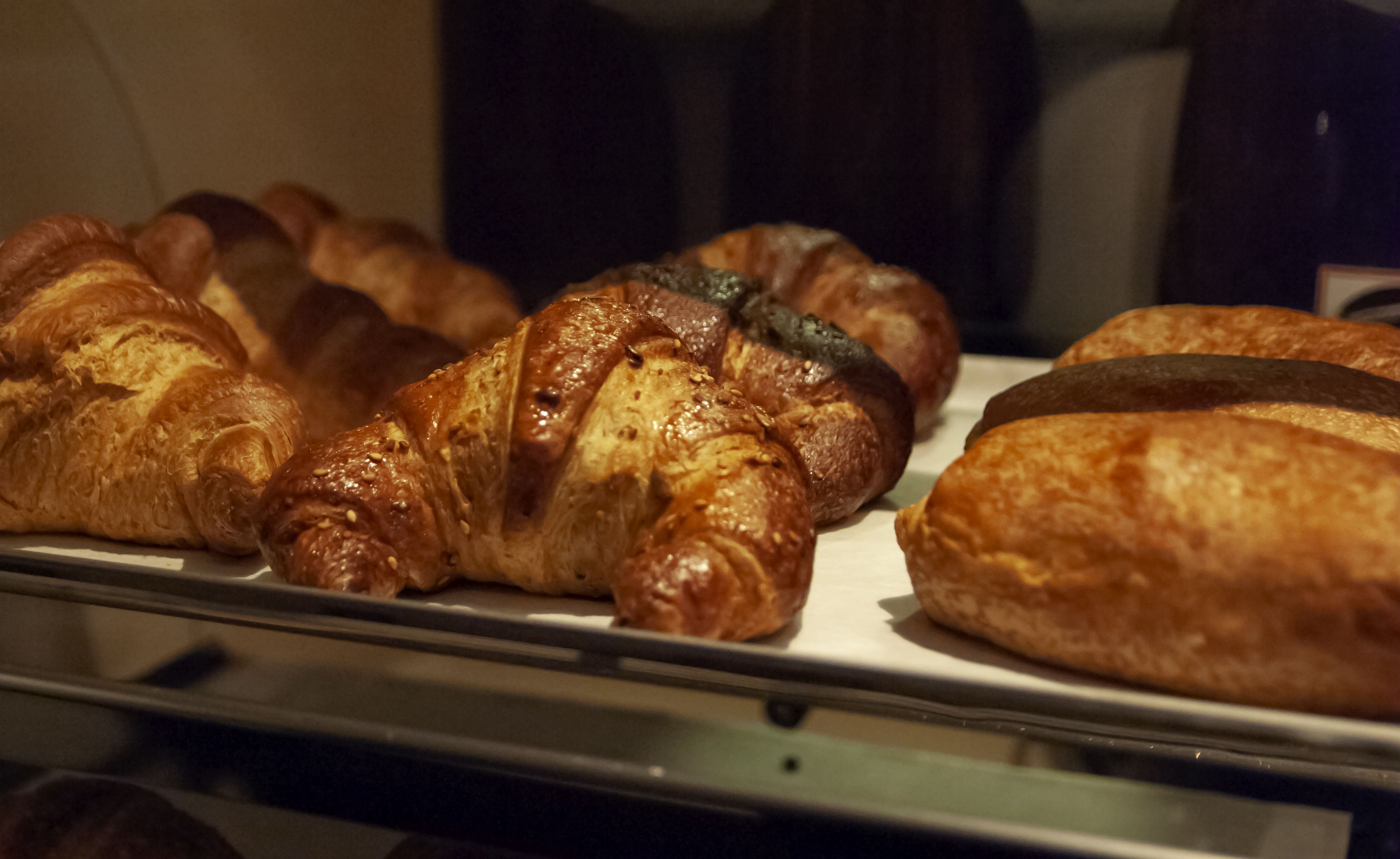 A display of various baked goods, likely pastries, arranged on a metal rack.