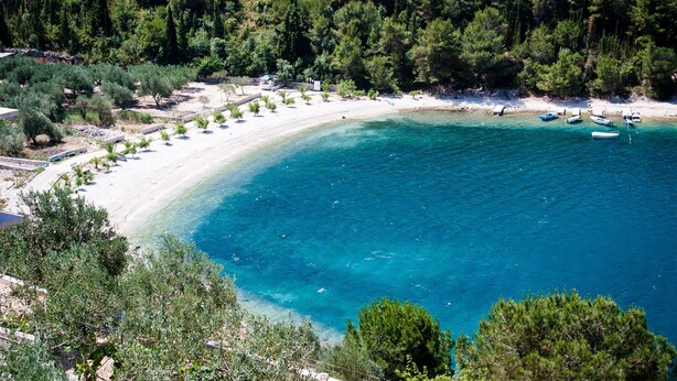 A coastal area with a sandy beach, clear blue waters, and dense green trees. - Luxury stone house with private pool, complete privacy in a relaxing atmosphere (Kremena)