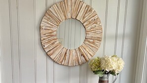 A wooden desk with drawers, a round mirror, a vase with flowers, and a wicker basket against a paneled wall. - Ocean views everywhere! / Beach access in front of house! /close to restaurants. (Isle of Palms)