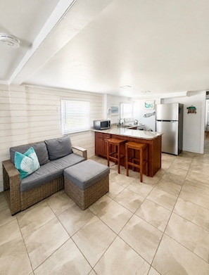 A compact kitchen with a built-in refrigerator, a microwave, and a sink. - Across the street from  beach with ocean views and access/close to restaurants! (Isle of Palms)