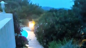 A stone pathway with a lamp post and a circular light fixture. - 2026 Comfort rental private heated pool 2 bedrooms air conditioning (Porto-Vecchio)