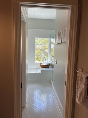 Separate bathtub and shower, hair dryer, towels, soap