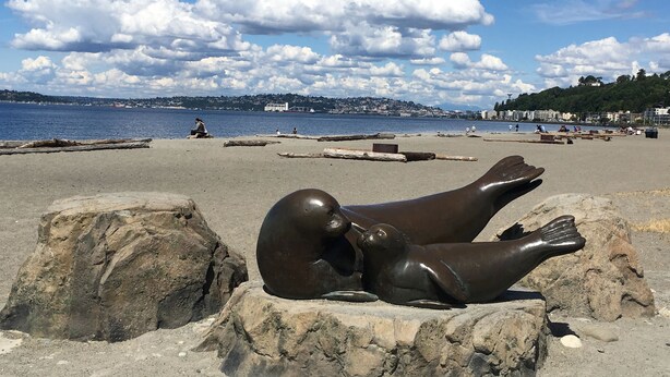 Une plage ornée d’une sculpture représentant deux personnages.
