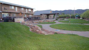 A residential building with a landscaped yard, a pathway, and a mountain backdrop. - Tacit Shadow "Aviator", Private Bedroom at base of Brian Head Mountain, WiFi (Parowan)