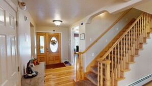 A hallway with a wooden staircase, a door with a glass panel, and a ceiling light. - Tacit Shadow "Aviator", Private Bedroom at base of Brian Head Mountain, WiFi (Parowan)