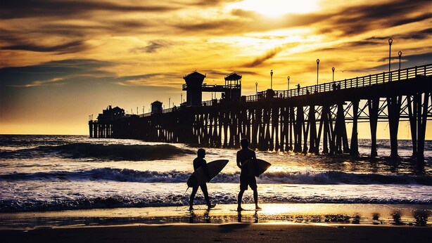 A pier extending into the ocean with a lighthouse and a tower structure at the end. - Come stay at our spacious beach house! (Oceanside)