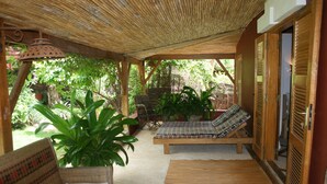 A covered outdoor seating area with wooden furniture and potted plants. - ONE OF THE MOST ELEGANT VILLAS IN THE SMALL COAST (Saly)