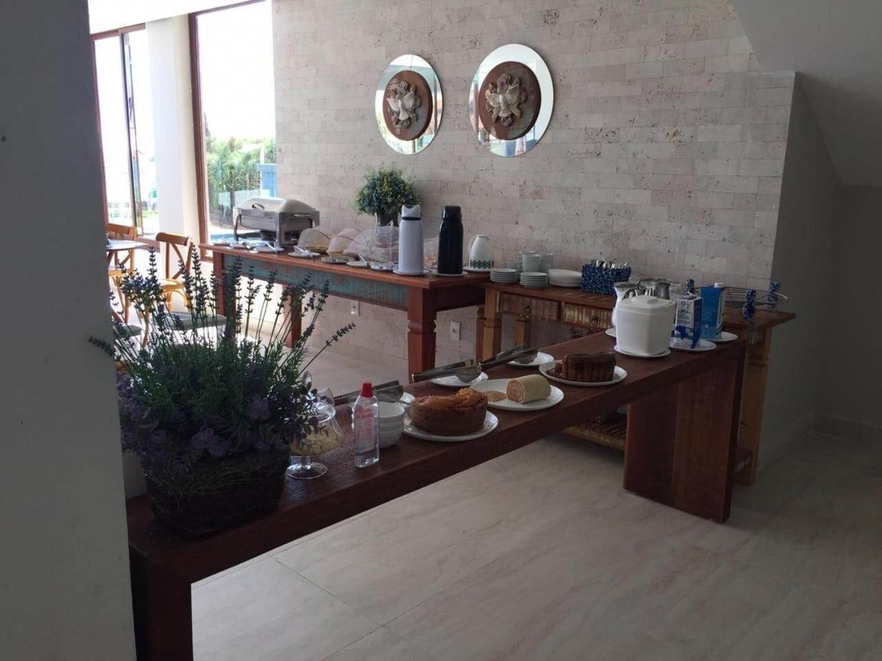 A kitchen area with a wooden counter, various kitchen appliances, and decorative items.
