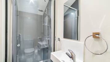 Regadera, secadora de cabello, toallas, papel de baño