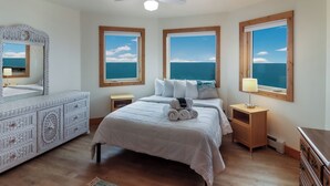 A bedroom with a bed, a dresser, a nightstand, and a ceiling fan. - Spruce at Lake Bluff Preserve-Lake Michigan Views-Sleeps 20  (Frankfort)