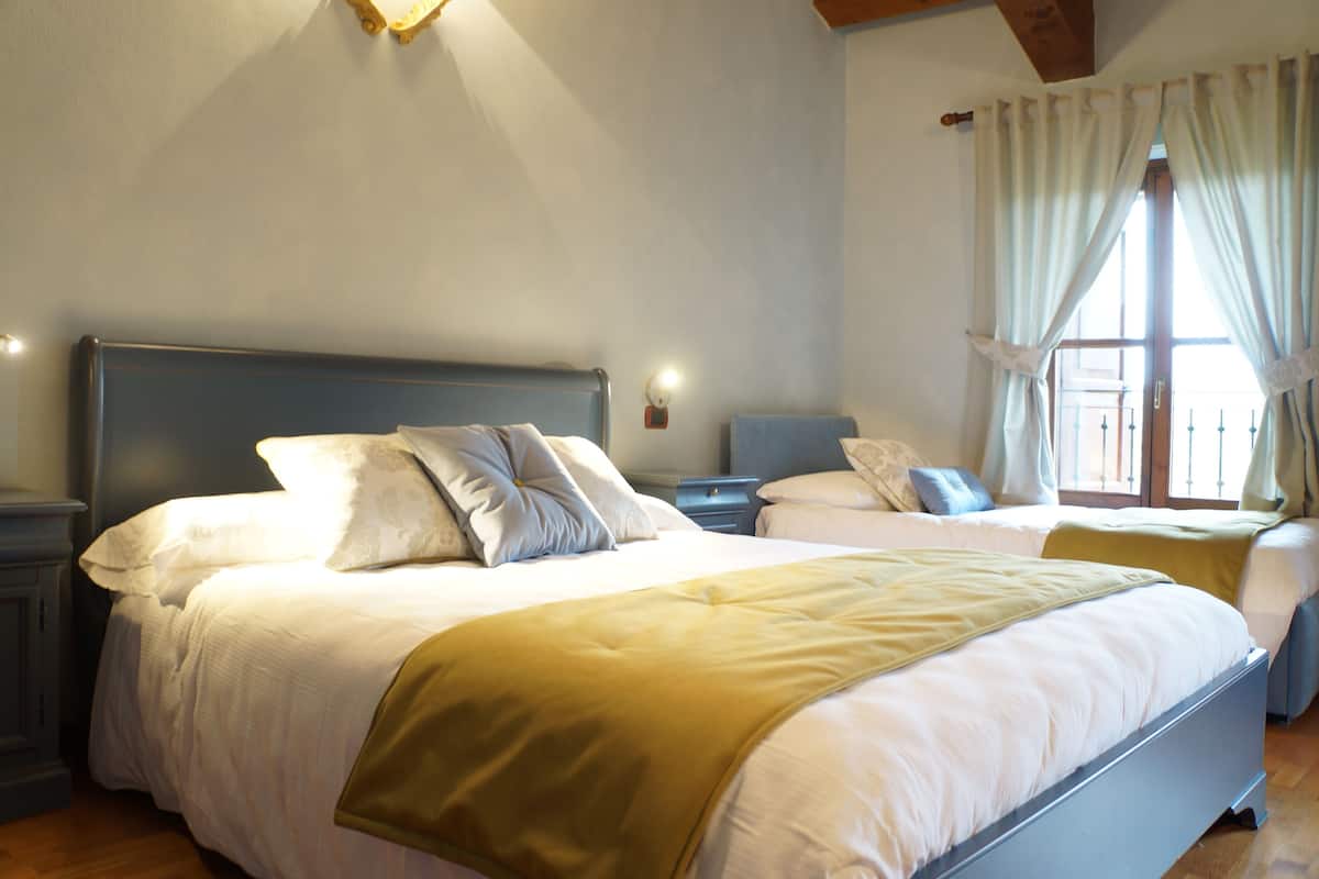 A double bed with a headboard, a bedside table, and a nightstand.