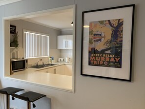 A kitchen with a microwave, toaster, and sink. - Riverland family escape (Sunlands)