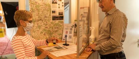 A reception desk with a map and informational posters.