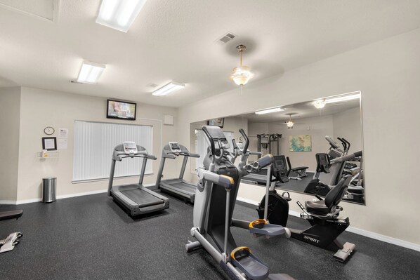 A gym with treadmills, elliptical machines, and a mirror. - Sleeps 8, dog friendly, private beach, beach service for 4! NEW BEACH RAMP! (Miramar Beach)