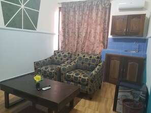 Basic Suite | Living area | 32-inch flat-screen TV with satellite channels, TV - Medrie International Hotel (Freetown)