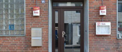 A brick building with a sign reading "Früh KÖLSCH" above the entrance.