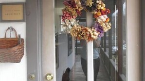 A door with a wreath hanging on it.