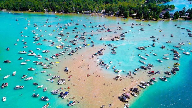 An aerial view of a beach with numerous boats and people. - Secluded Torch Lake Cabin, 3BR, Sleeps 8, Firepit (Bellaire)