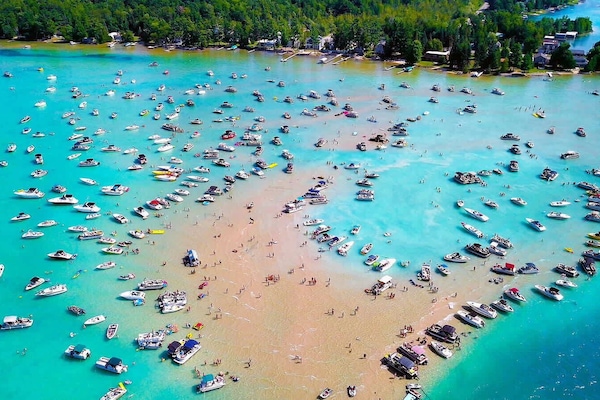 The famous Torch Lake sandbar, minutes from Eagles Landing — turquoise water, summer crowds, and the kind of lake day that Northern Michigan is famous for