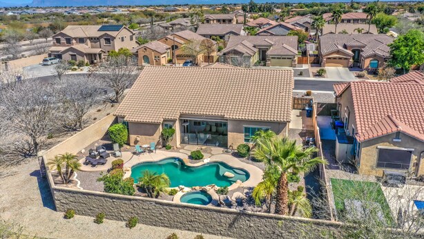 A residential area with houses, a swimming pool, and a clear view of the mountains.
