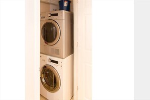 Convenient laundry facilities with two front-loading washing machines.