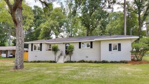 A single-story house with a front porch, a small front yard, and a tree to the left. - The Masters Rental! Less than half a mile from course! (Augusta)