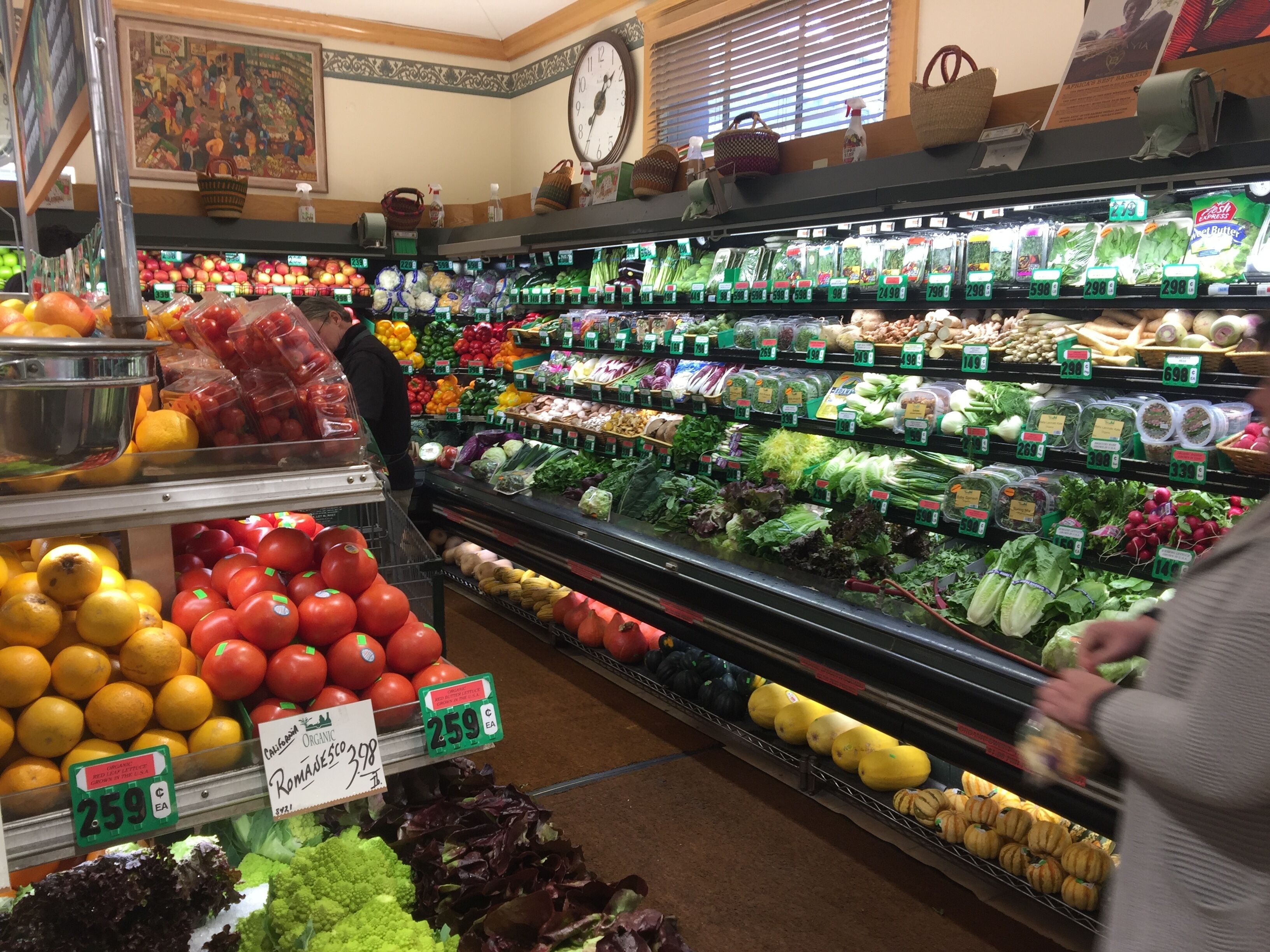 A grocery store with fresh produce and packaged goods on shelves.