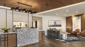 Uma sala de estar moderna com um balcão de recepção em mármore, piso de madeira e mobiliário contemporâneo.