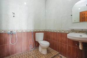 A bathroom with a toilet, a sink, and a shower. - RedDoorz Plus near Alun Alun Kejaksan Cirebon (North Cirebon)