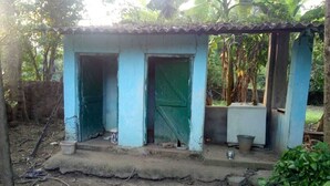 A small, single-room structure with a corrugated metal roof and a green door. - Dandak Tribes Homestay and Tourism group! Bastar Homestay! (dantewada)