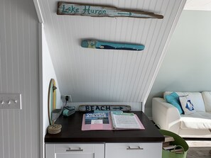 A room with a desk, a whiteboard, and a couch.
