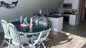 A modern kitchen with white cabinets, a built-in microwave, and a stainless steel stove. - Riverfront A-Frame w/ Dock, Kayaks, Putt-Putt & Shuffleboard (Oscoda Twp)