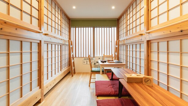 A traditional Japanese room with tatami flooring, low wooden tables, and shoji screens. - Ten Apartment Hotel (Fukuoka)