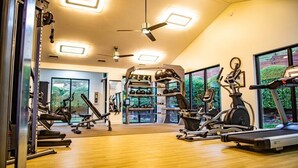 A gym with treadmills, stationary bikes, and weight machines.