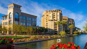 A modern hotel with a river view, featuring a central courtyard with a water feature and red flowers. - LUXURY 2br/2baRemodel in the HEART of Scottsdale! HEATED POOL, GYM, TENNIS COURT (Scottsdale)