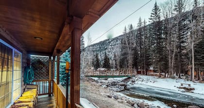Waterfront cabin with mountain view, wood stove, private hot tub, & WiFi