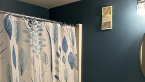 A bathroom with a shower curtain featuring a leaf pattern, a toilet, a sink, and a wall-mounted vent. - 2nd Floor 'Sky Rise Vista' - Pool Access! (Sugar Mountain)