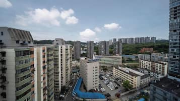 Complejo residencial de edificios altos con varios edificios de apartamentos, un estacionamiento y una estructura con techo azul.
